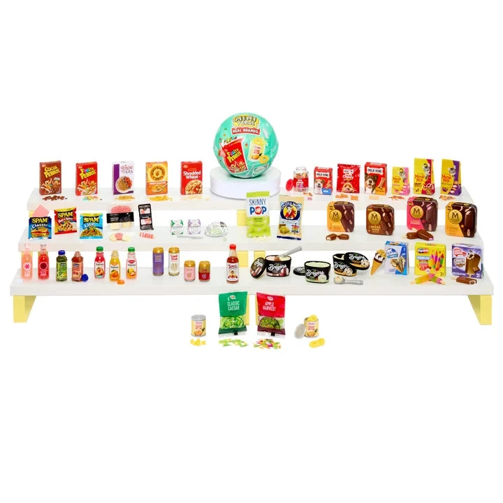 MGA's Miniverse Real Brands Series 2 miniature grocery collection arranged across white display shelves, featuring cereals, snacks, drinks, condiments, ice cream and a turquoise mystery capsule.