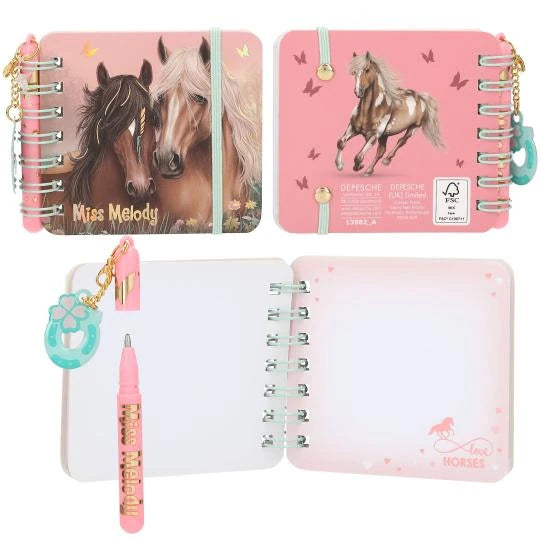 Miss Melody mini notebook with two horses on the cover, a standing horse on the back, an open notebook and a pink pen.