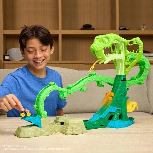 Child playing with a mini monster truck on the front ramp of the Monster Jam Cobra's Crazy Escape playset