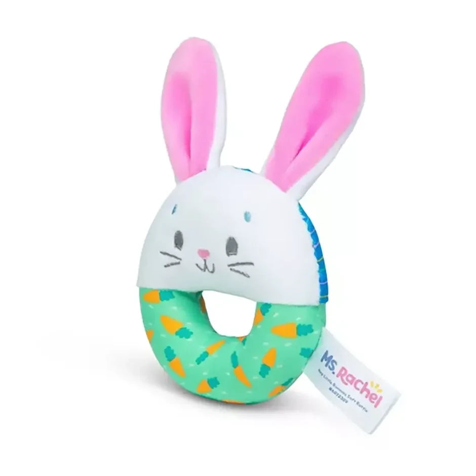 Side view of Ms. Rachel Hop Little Bunnies soft rattle with pink ears, bunny face and green patterned ring