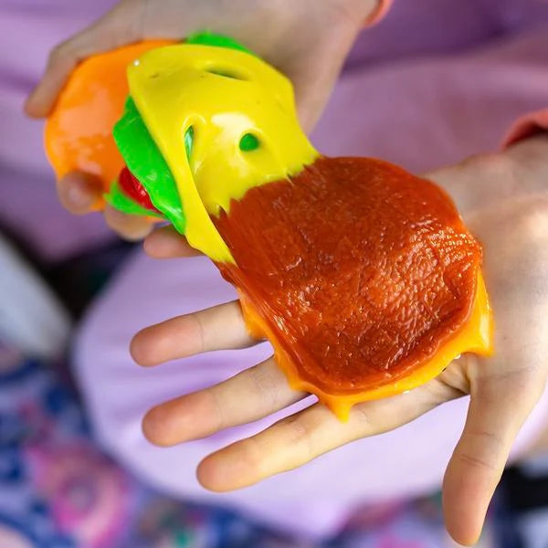 Mushmeez Taba Squishy burger design being pulled apart by hand to show the bun, filling and layered construction