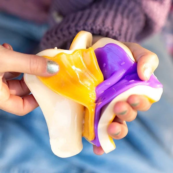 Mushmeez Taba Squishy sandwich design being pulled apart by hand to show the coloured layers