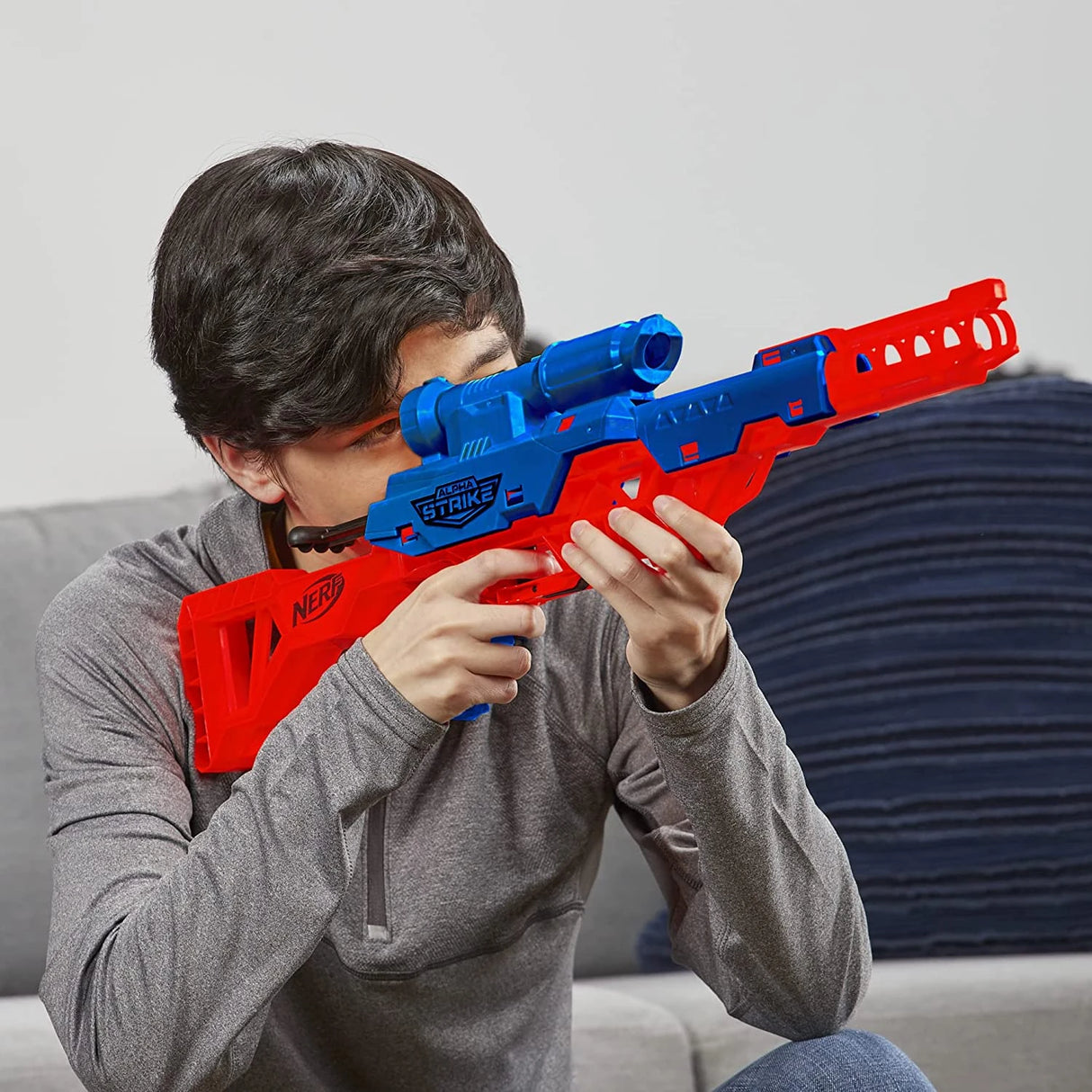 Person holding a blue and red Nerf Alpha Strike Wolf LR-1 blaster indoors