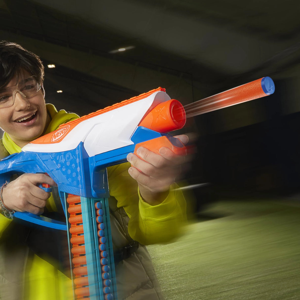 Person wearing safety glasses holding NERF N Series Infinite blaster with orange dart visible in front of barrel