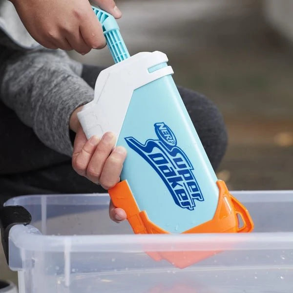 NERF Super Soaker Torrent water blaster being refilled in water