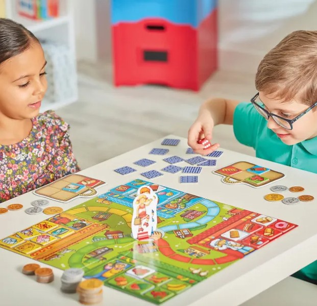 Children playing Pop to the Shops board game by Orchard Toys in Ireland