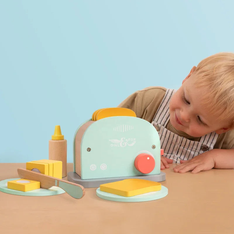 Child playing with Owl and Fox Wooden Toaster Set with toy toast and condiments – Ireland