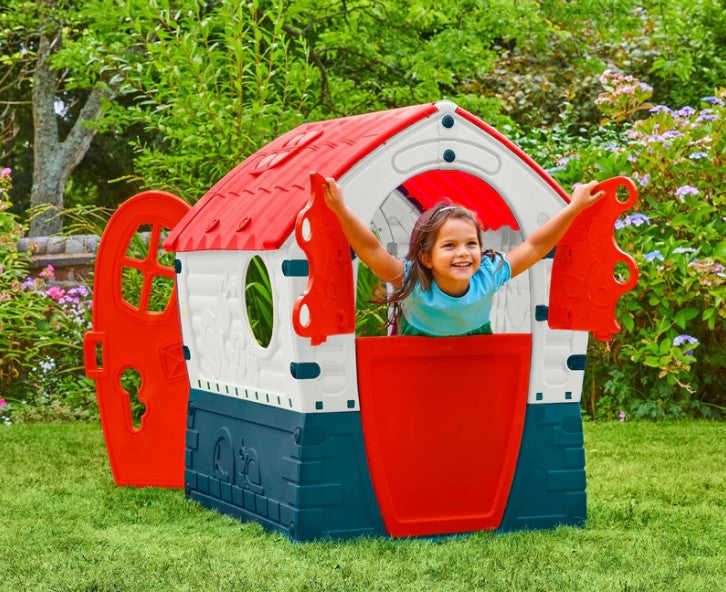 Child playing in Palplay Dream House Playhouse in the garden – Ireland