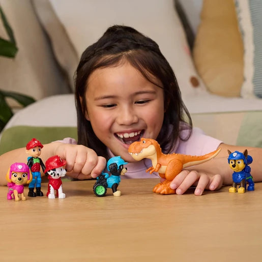 Child playing with PAW Patrol Dino Adventure figures on a table