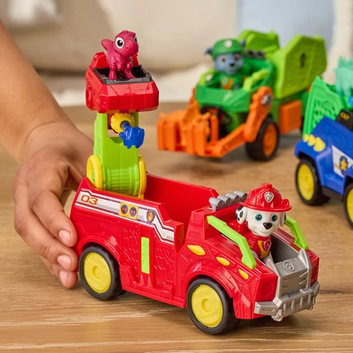 Child pushing the PAW Patrol Marshall Dino Rescue Fire Truck with other Dino Movie rescue vehicles behind