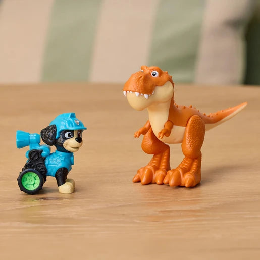 PAW Patrol Rex figure beside an orange dinosaur figure