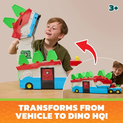 Child lifting the upper section of the PAW Patrol Dino Mobile Headquarters while another child plays with the vehicles