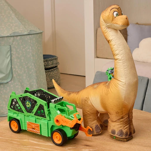 Green Megasaurus Dino Vehicle beside the inflated long neck dinosaur in a playroom