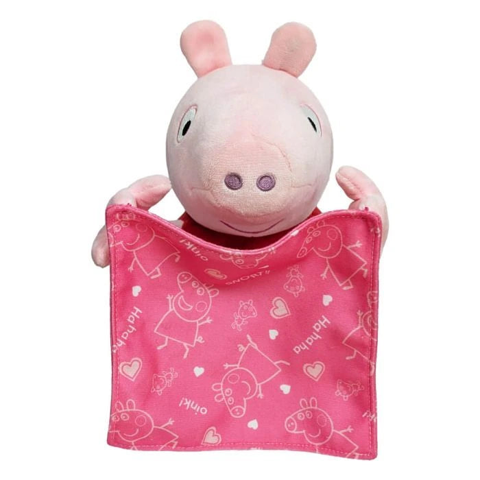 Peppa Pig soft toy facing forward while holding a square pink blanket printed with Peppa Pig characters and hearts
