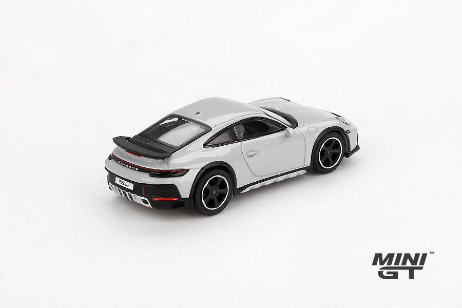 Mini GT Porsche 911 Dakar Ice Grey Metallic LHD prototype viewed from the rear left showing the rear light bar, black spoiler and raised body height