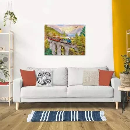 Completed Ravensburger Autumn Viaduct puzzle displayed on a wall above a sofa