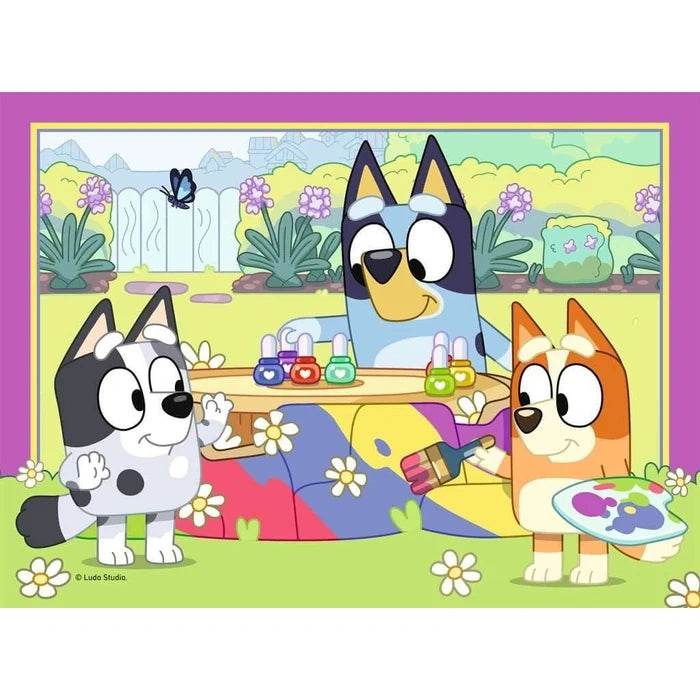 Ravensburger Bluey jigsaw with Bluey, Bingo and Muffin painting together in the garden