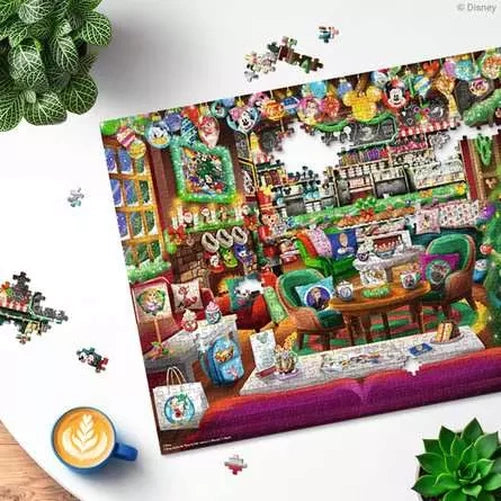 Ravensburger Disney Christmas Cafe puzzle detail showing the decorated café scene surrounded by loose jigsaw pieces