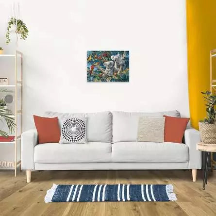 Finished Koalas in a Tree puzzle displayed on a living room wall above a sofa