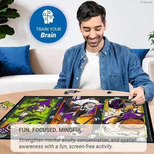 Man assembling the Ravensburger The Nightmare Before Christmas jigsaw puzzle on a table with loose pieces around the artwork