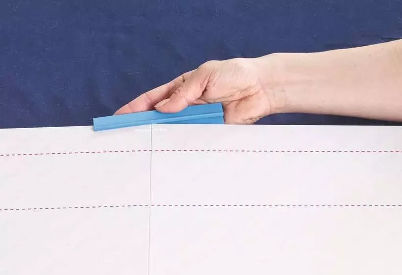 Close up of blue securing bracket being attached to Ravensburger Puzzle Handy Fold & Go board edge