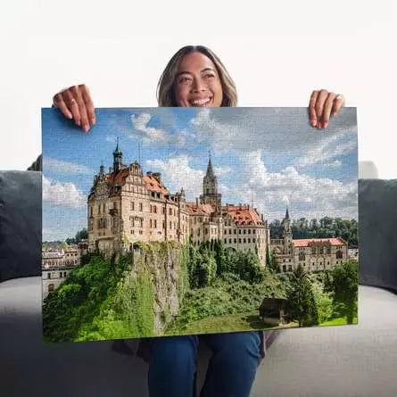 Ravensburger Sigmaringen Castle 1000 piece jigsaw puzzle held up completed by a person