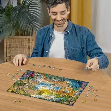 Person assembling the Tiger Family in Oasis puzzle on a table