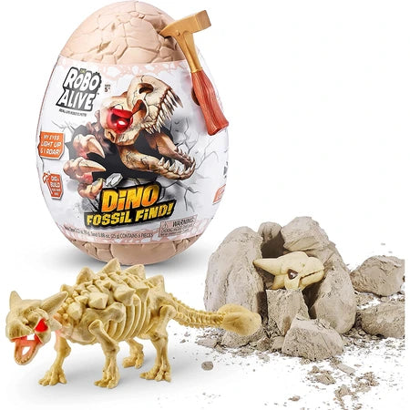 Robo Alive Dino Fossil Find egg packaging with dinosaur skull graphic, gold hammer, dinosaur skeleton figure and broken rock pieces on white background