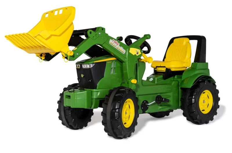 Green Rolly Farmtrac John Deere 7310R toy tractor with yellow loader raised on a white background