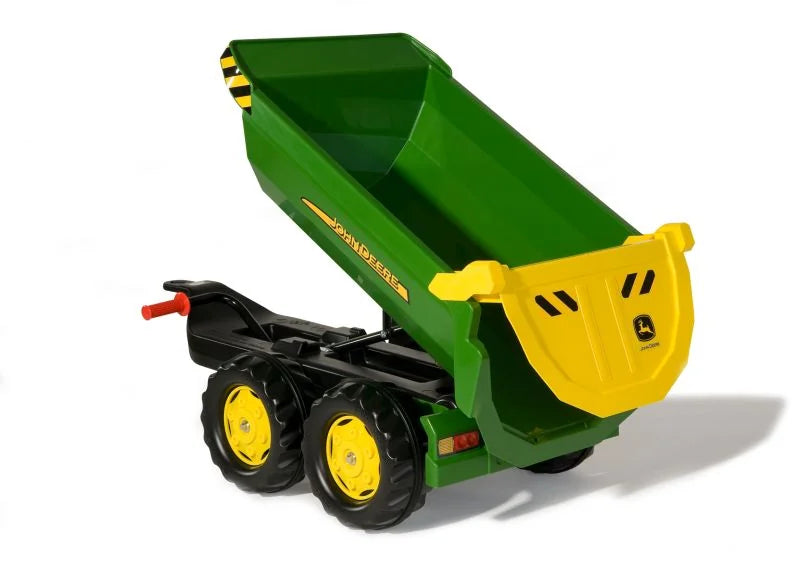 Rolly John Deere halfpipe trailer tipping forward with its green body raised and yellow tailgate visible.