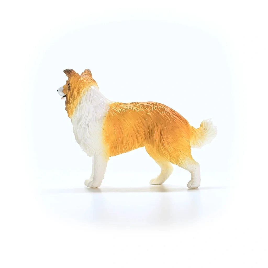 Schleich Collie figure shown from the left side with a white chest, open mouth and one front leg raised