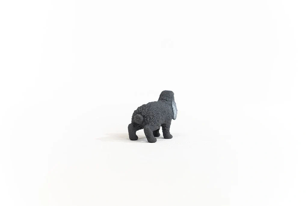 Rear view of the Schleich Lop-Eared Rabbit figure showing its rounded tail, textured grey coat and back legs
