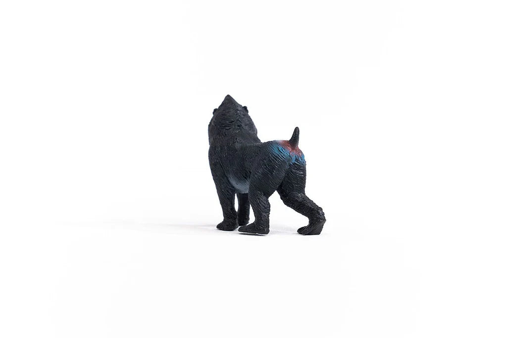 Schleich Mandrill figure with a dark textured coat, blue and red markings across the hindquarters and a short upright tail.