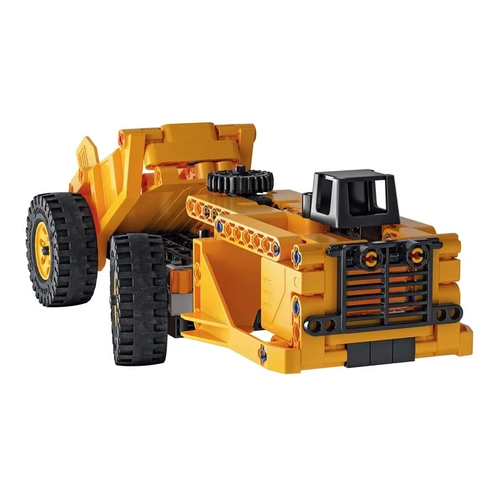 Low profile yellow and black truck model with four large wheels, front grille and exposed construction pieces.