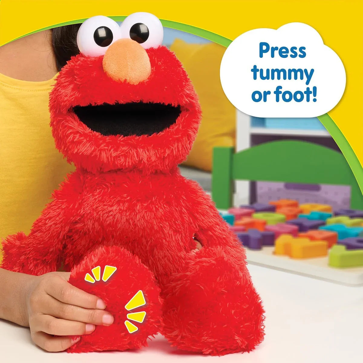 Child pressing Elmo’s foot to activate wiggles and giggles on Tickle Me Elmo toy – Ireland.