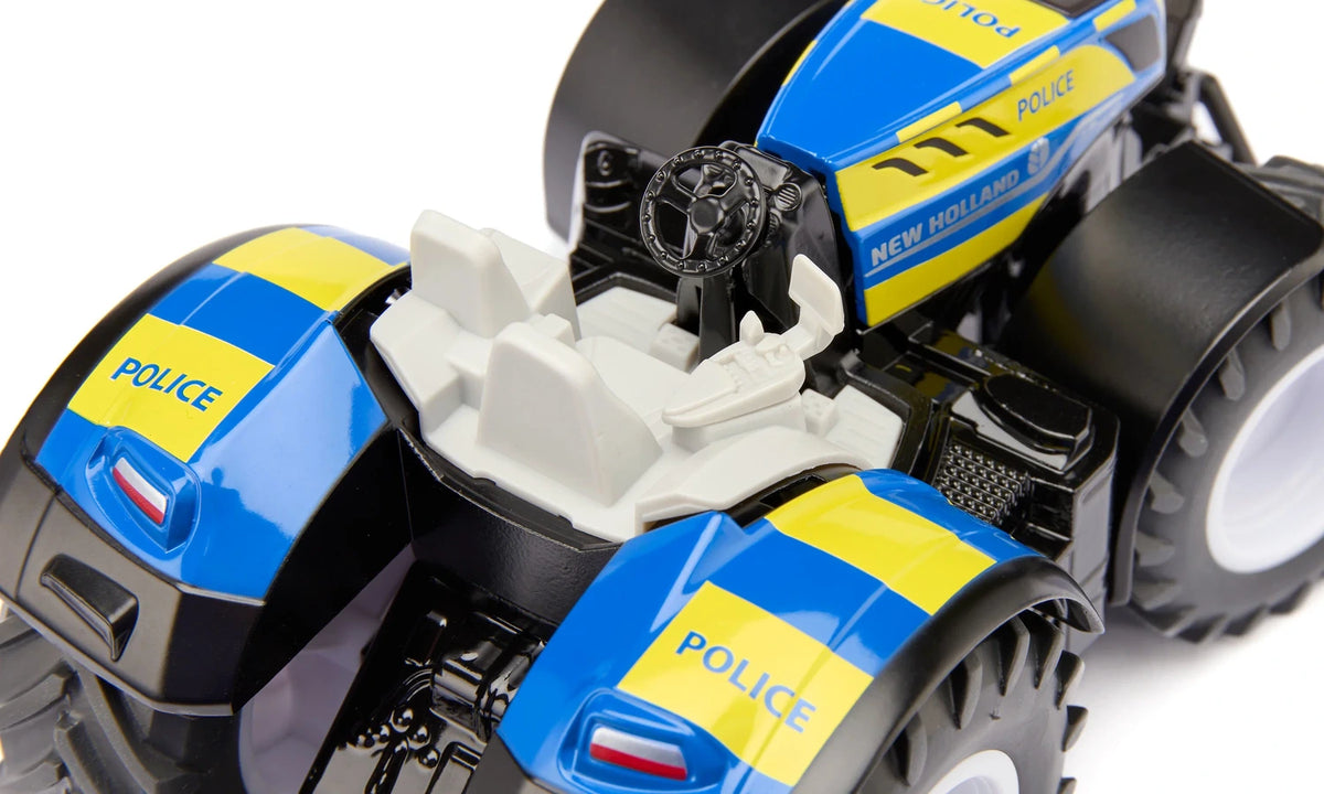 Siku New Holland Police Tractor 3297 with the cab removed to show the white seat, steering wheel and interior controls