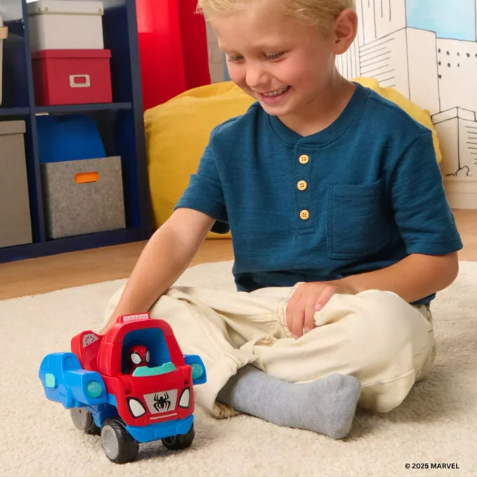 Child playing indoors with Spidey and His Amazing Friends Transforming Web-Wave Cruiser toy