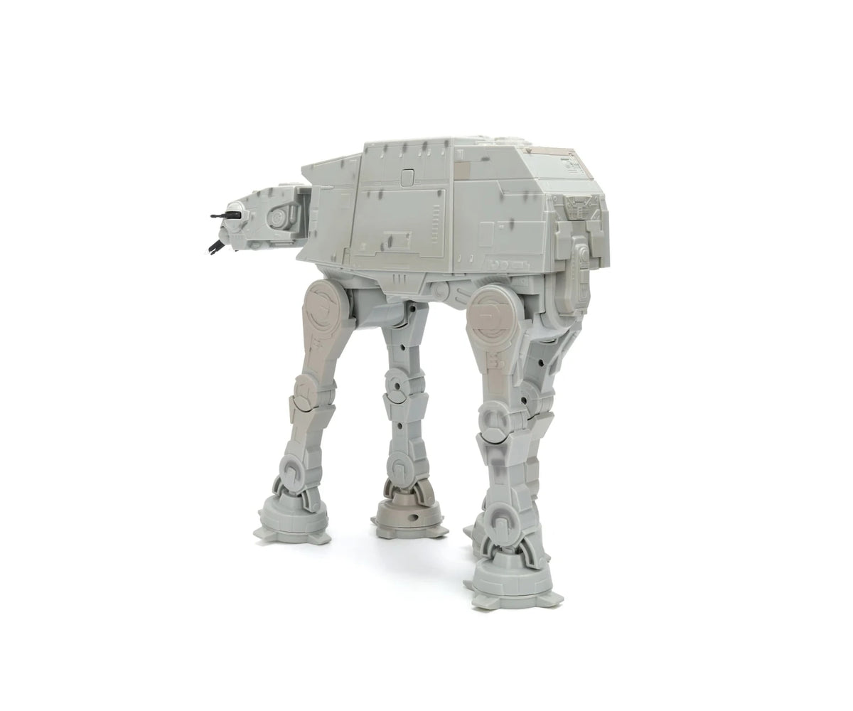 Star Wars RC Walking AT-AT viewed from the rear and side, showing its grey armoured body, mechanical leg joints and four broad feet.