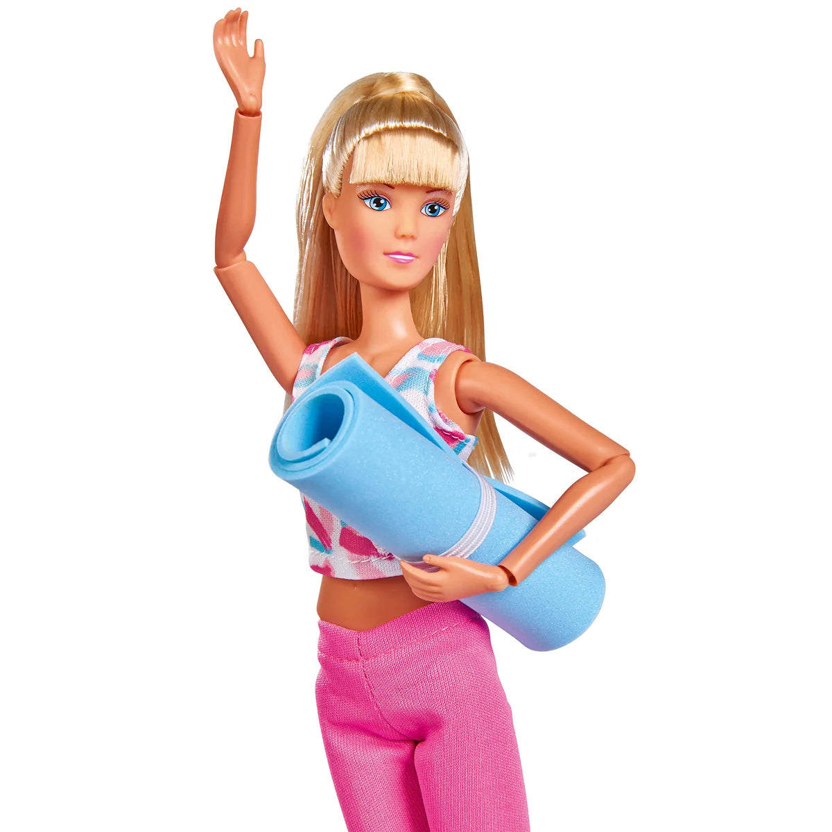 Steffi holding a rolled-up yoga mat in workout gear, hand raised – Ireland