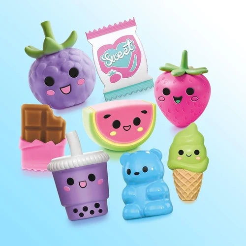 Colourful decorative toppers shaped like fruit, sweets, a drink, bear and ice cream