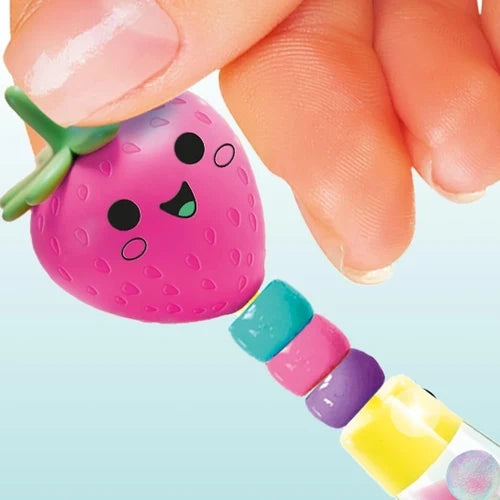 Pink strawberry topper being attached above colourful beads on a clear pen