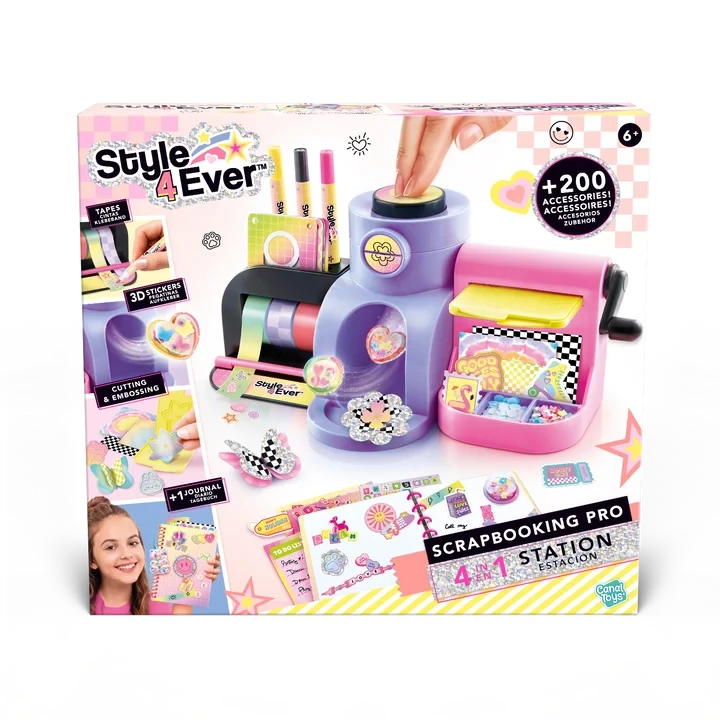 Front of the Style 4 Ever Scrapbooking Studio Pro packaging showing the purple and pink workstation with a turning handle, colourful tape rolls, craft markers, sticker decorations and a decorated scrapbook.