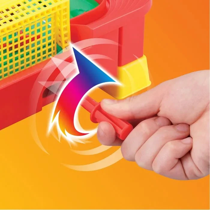 Close-up of a hand turning a red striker lever beside a yellow goal