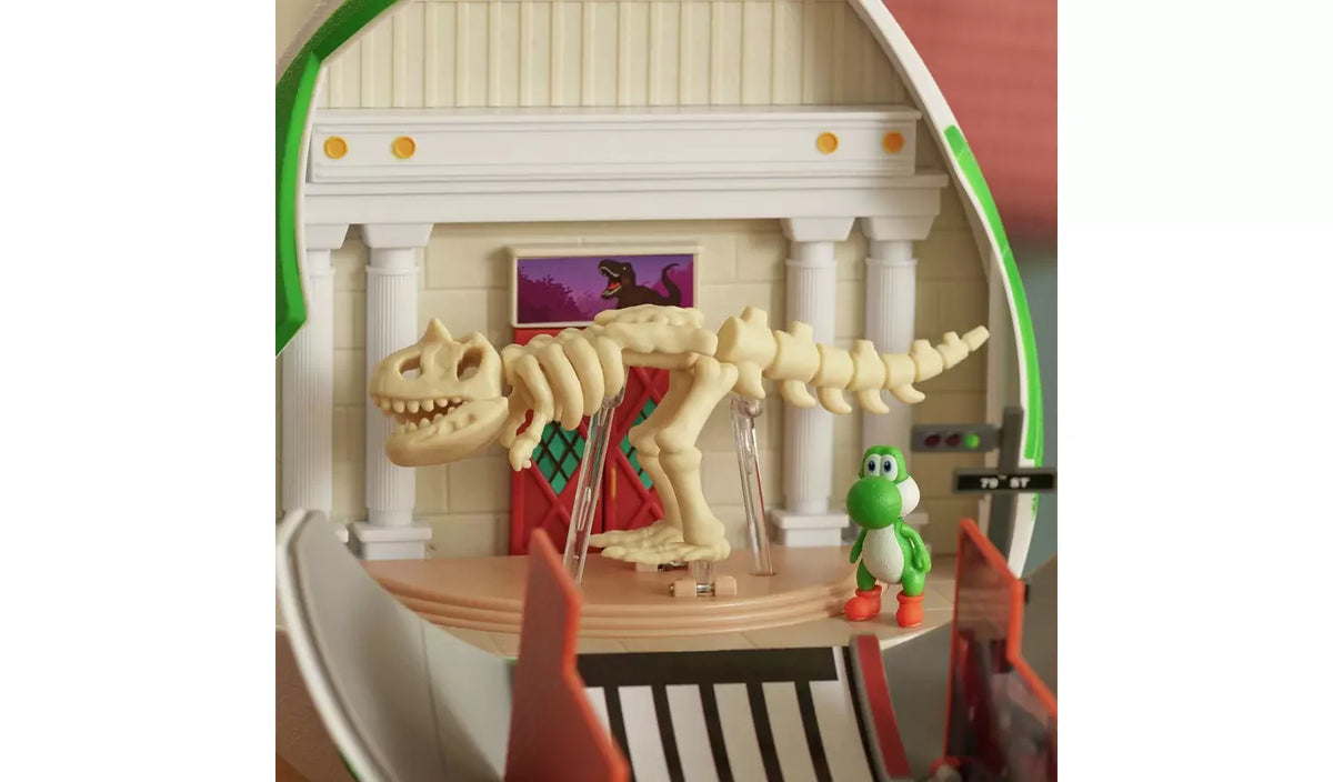 Museum scene inside the Yoshi Egg Playset featuring a fully assembled cream dinosaur skeleton standing on a display platform, with Yoshi beside it and red museum doors behind.