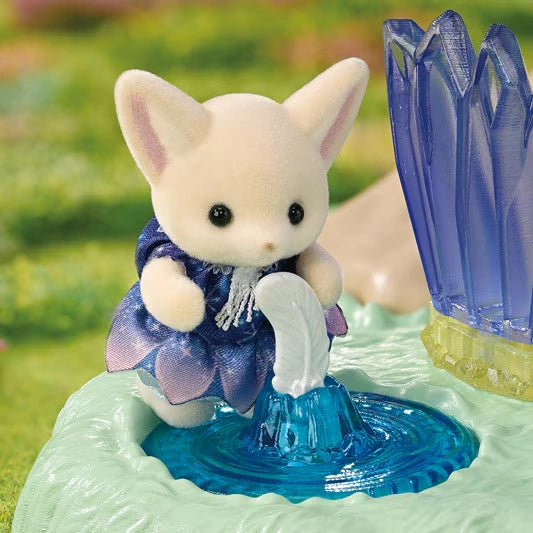 Close-up of a Fennec Fox baby wearing a dark blue and purple flower petal dress beside a white water spout and bright blue fountain basin, with purple crystals on the right.