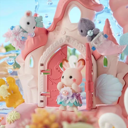 Sylvanian Families Baby Mermaid Castle shown close up with small animal figures at the front door