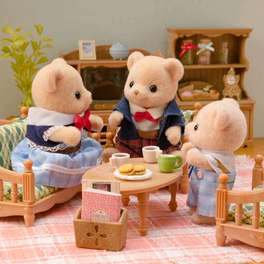 Biscuit Bear figures shown around a small table in a living room scene