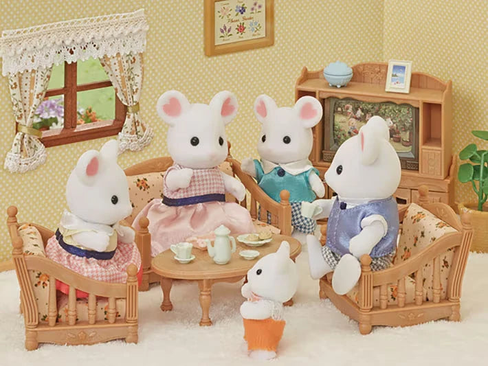 Four Marshmallow Mouse figures shown in a living room scene with sofas, table and cabinet