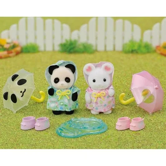 Play scene of Sylvanian Families Rainy Day Duo showing figures splashing with umbrellas, boots and puddle in Ireland.