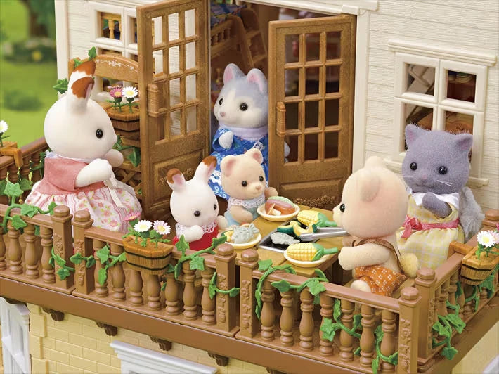 Close-up of Sylvanian animal figures sitting around a table on the balcony